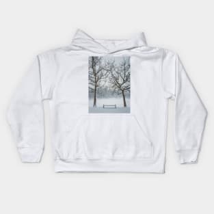 a bench under the snowy trees Kids Hoodie